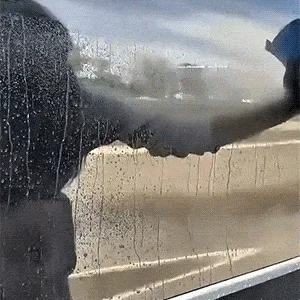 Car being washed with water beading off